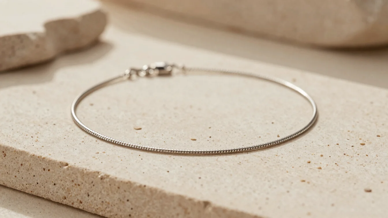 Warm editorial studio photography of a fine steel necklace restin