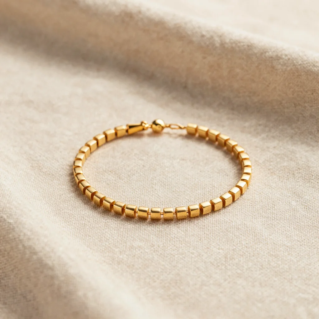 Delicate gold stainless steel bracelet on natural beige linen cloth, soft daylight, warm editorial studio photography, 8